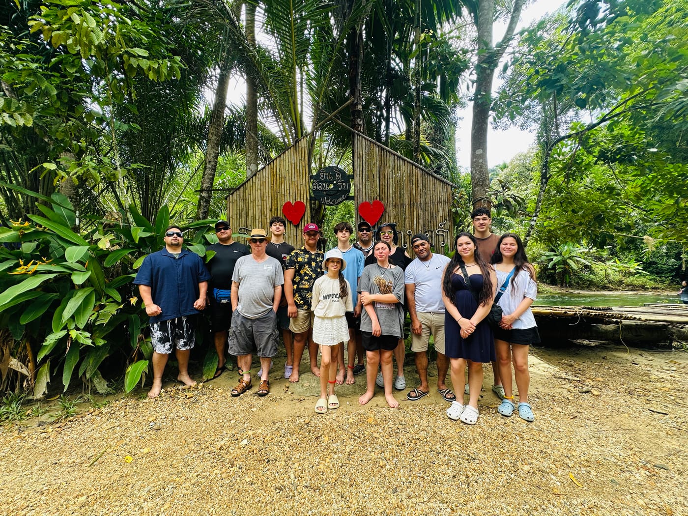 Travel group at a jungle welcome sign